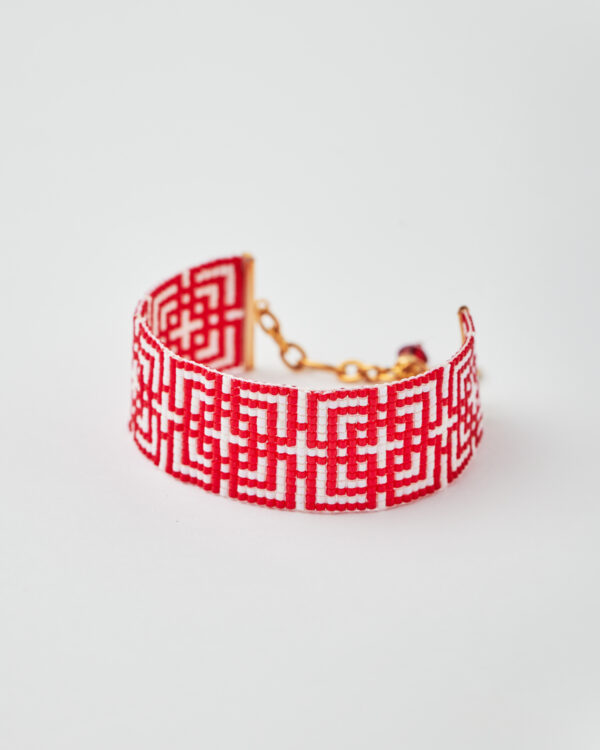 Handmade Miyuki loom-stitched bracelet with red and white geometric maze design.