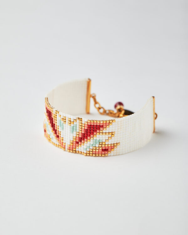 Handmade Miyuki loom stitched bracelet with red, gold, and white swan design.