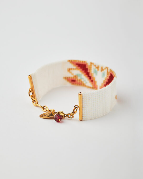 Intricate loom stitched bracelet with Miyuki beads in red, gold, and white featuring a swan design.