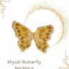 Miyuki butterfly necklace in golden tones displayed against a white background with decorative gold accents.