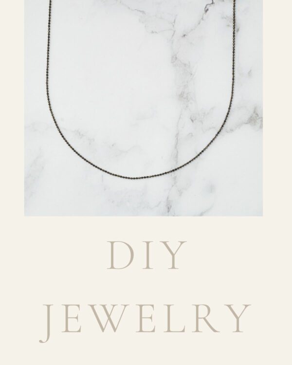 Long chain necklace featuring stylish black and gold dots, showcasing a modern and elegant design.