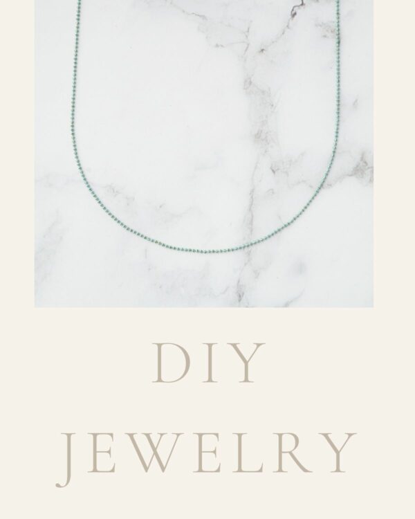 Long chain necklace adorned with mint-colored dots, featuring a stylish and contemporary design.