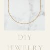 Long chain necklace with petite dots in 24k gold on marble background