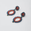 Bold red and blue earrings made with Miyuki SuperDuo beads and gold accents, in a radiant circular pattern.