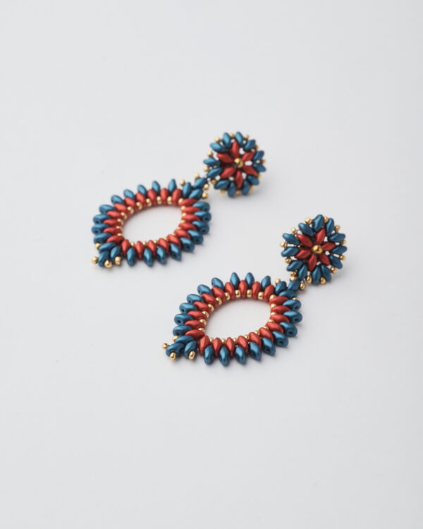 Bold red and blue earrings made with Miyuki SuperDuo beads and gold accents, in a radiant circular pattern.