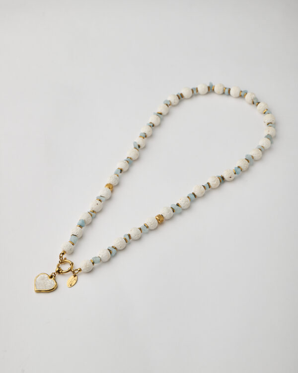 Full handmade necklace with white lava beads, aquamarine stones, and gold heart charm by The Gem Stories