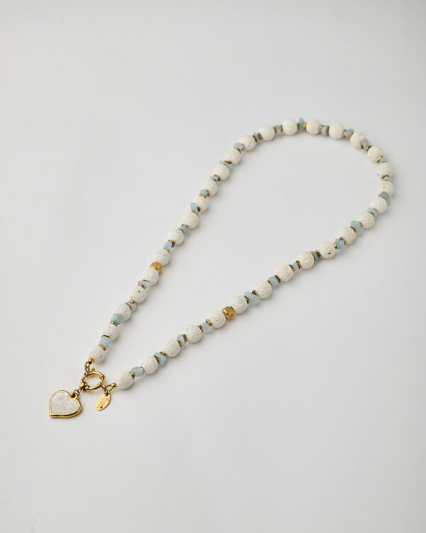 Full handmade necklace with white lava beads, aquamarine stones, and gold heart charm by The Gem Stories