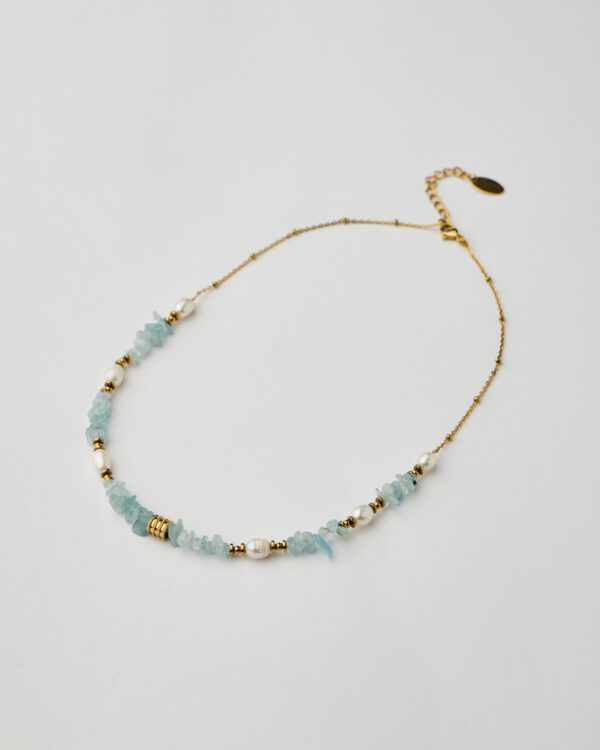 Full view of handmade necklace with aquamarine stones, pearls, and gold chain