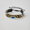 Handmade Miyuki bracelet with geometric evil eye design in black, gold, and blue