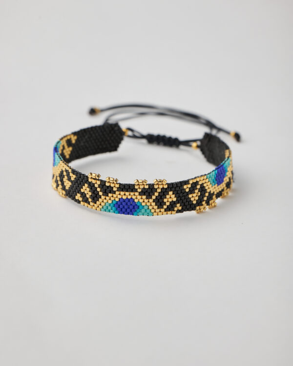 Handmade Miyuki bracelet with geometric evil eye design in black, gold, and blue