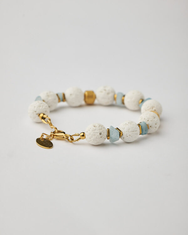 Handmade bracelet with white lava beads, aquamarine stones, and gold plated clasp