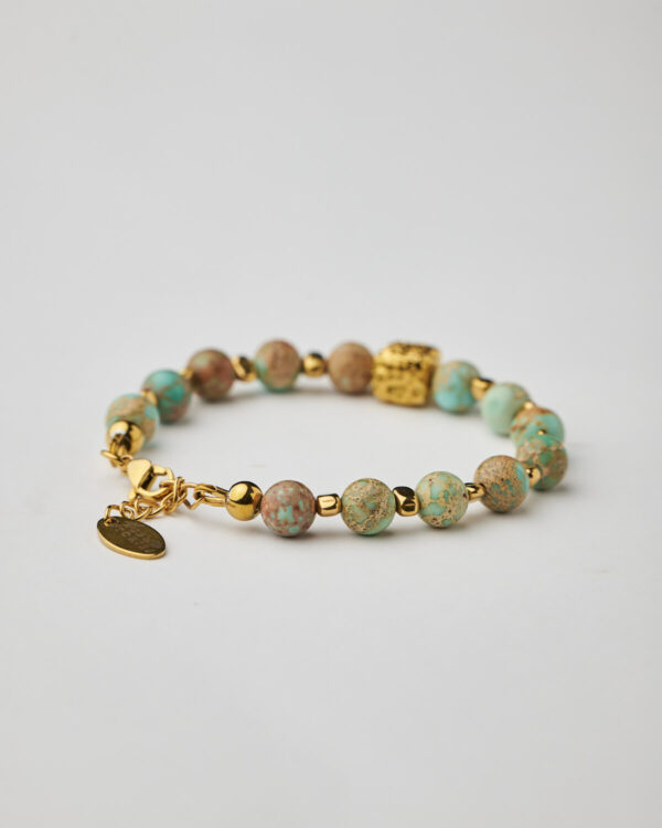 Turquoise bracelet with gold plated clasp and textured cube by The Gem Stories