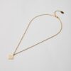 Full view of minimal gold-plated pendant necklace with geometric design