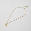 Full view of gold heart pendant necklace with turquoise stone
