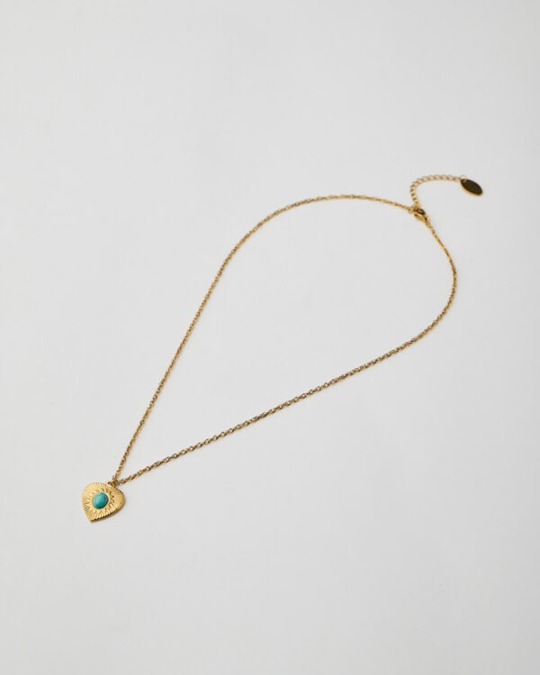 Full view of gold heart pendant necklace with turquoise stone