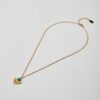 Gold sunburst necklace with turquoise howlite stone