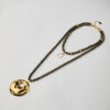 Full handmade necklace with golden hammered disc and black beaded strands