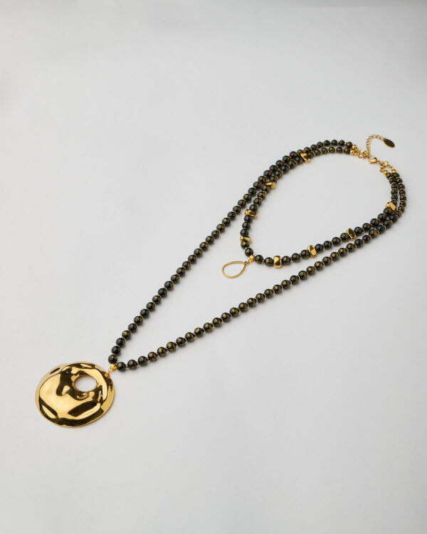 Full handmade necklace with golden hammered disc and black beaded strands