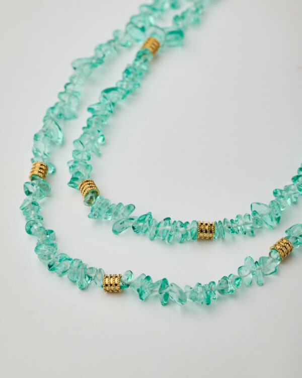 Close-up of aqua gemstone chip necklace with gold spacers
