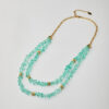Full view of handmade double-strand necklace with aqua crystal chips and gold elements