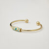 Front view of gold cuff bracelet with woven miyuki evil eye design