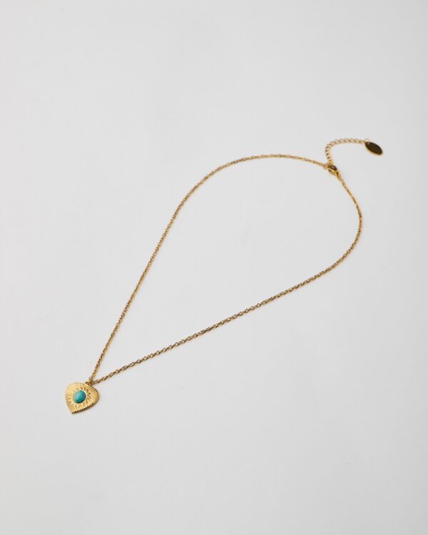 Full view of gold heart pendant necklace with turquoise stone