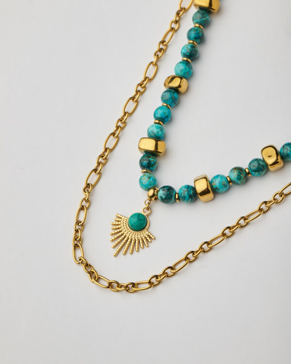 Close-up of marble aquamarine howlite necklace with sunburst pendant