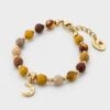 Natural jasper gemstone bracelet featuring faceted beads in earthy tones of ochre, terracotta, and sand, accented with gold-plated sphere spacers and a central gold crescent moon charm set with tiny sparkling crystals on a white background.