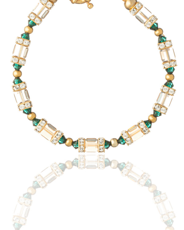 Detailed view of Allover Gold and Emerald Bracelet with crystals and gold-plated settings