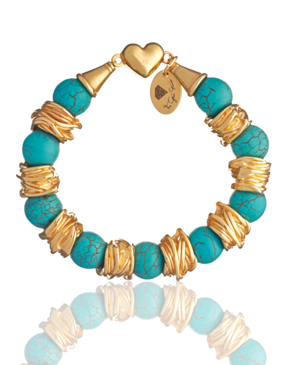 Handmade turquoise howlite bracelet with gold-plated twisted spacers and heart clasp by The Gem Stories
