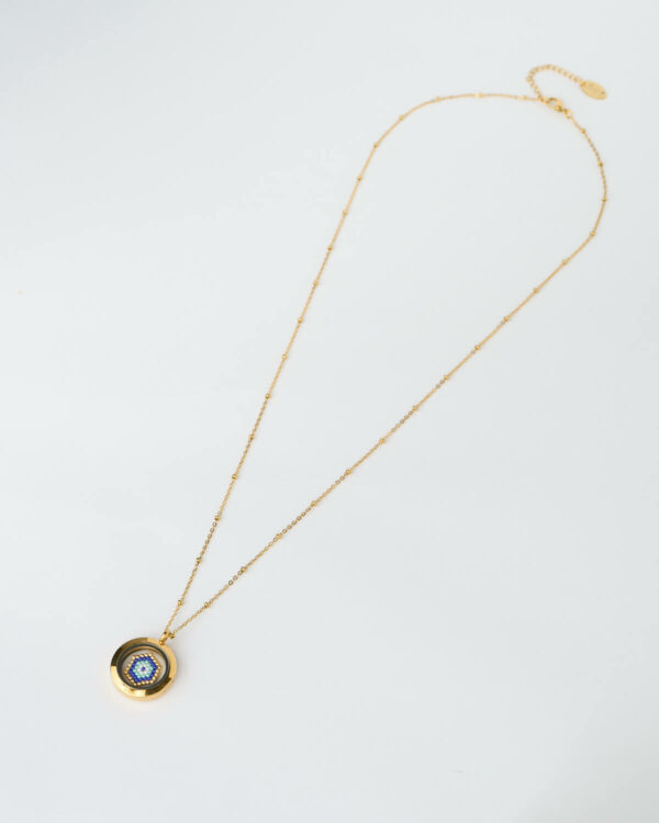 A handmade memory locket necklace featuring a blue evil eye design crafted from Miyuki beads. A protective symbol of harmony and light.