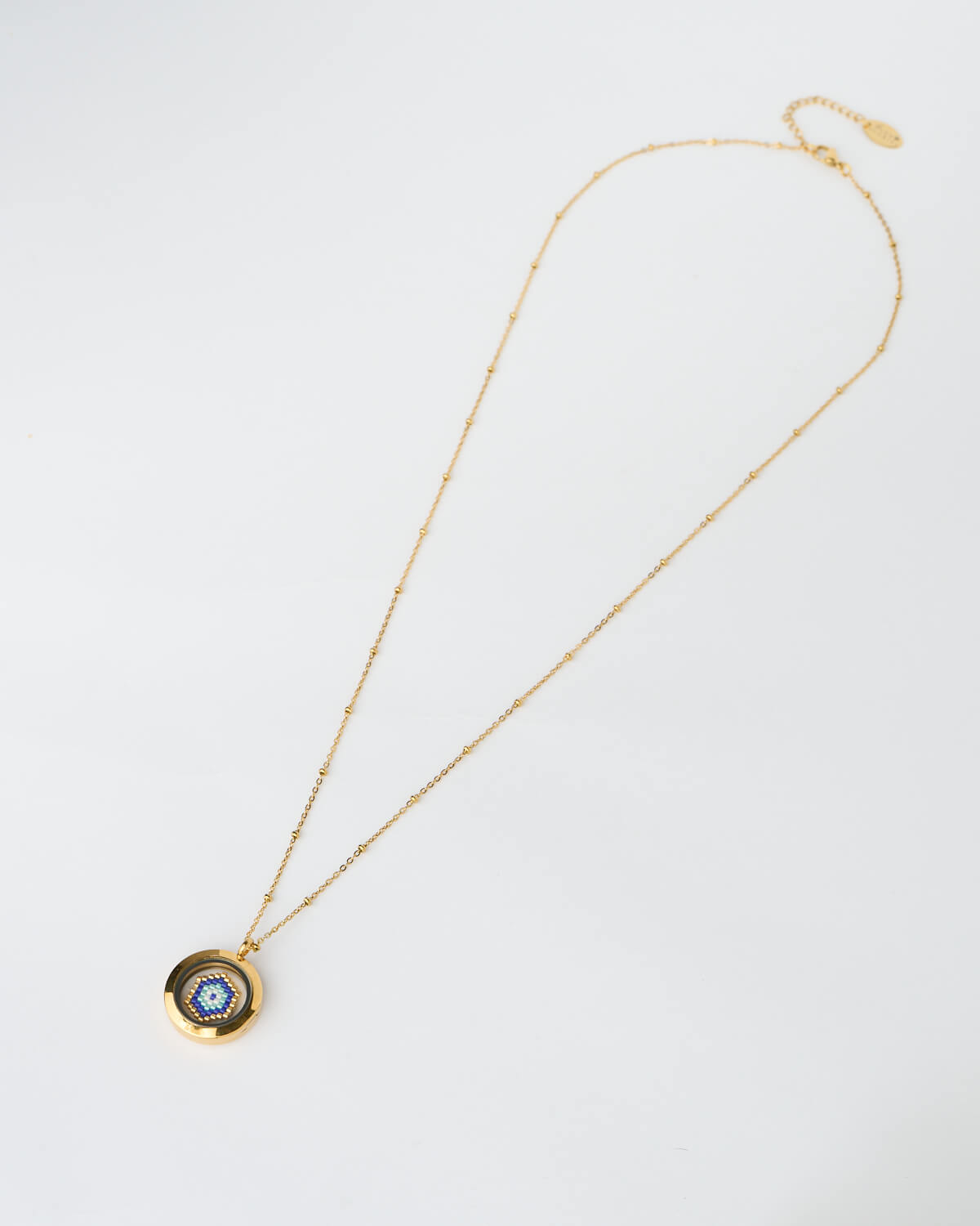 evil eye necklace, blue Miyuki necklace, handmade jewelry, protection pendant, The Gem Stories A handmade memory locket necklace featuring a blue evil eye design crafted from Miyuki beads. A protective symbol of harmony and light.