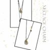 Gold Drop Necklace Charm by The Gem Stories – handmade pendant with gold and silver tones on black cord.