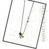 Black & Gold Dual Drop Necklace Charm by The Gem Stories – handmade pendant on black cord symbolizing balance and elegance.
