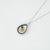 Silver teardrop memory locket necklace with blue gemstones and gold leaf charm by The Gem Stories
