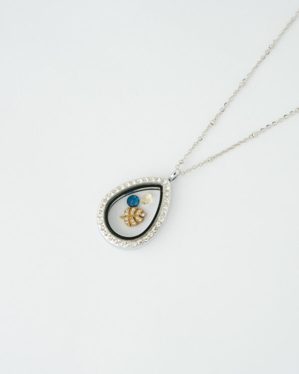 Silver teardrop memory locket necklace with blue gemstones and gold leaf charm by The Gem Stories