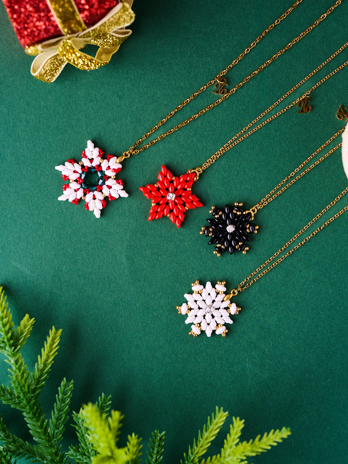 The-gem-stories-colorful-star-pendants-set XMAS Snowflake Necklaces in red, white, and black with 70cm gold chains by The Gem Stories