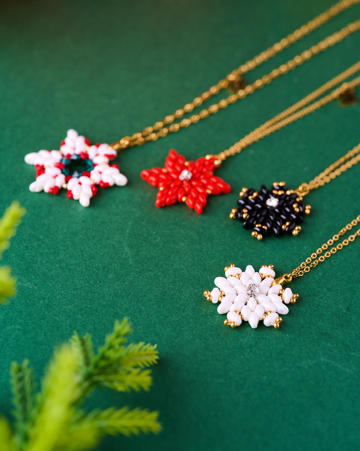 The-gem-stories-handmade-star-pendants-collection XMAS Snowflake Necklaces in red, white, and black with 70cm gold chains by The Gem Stories