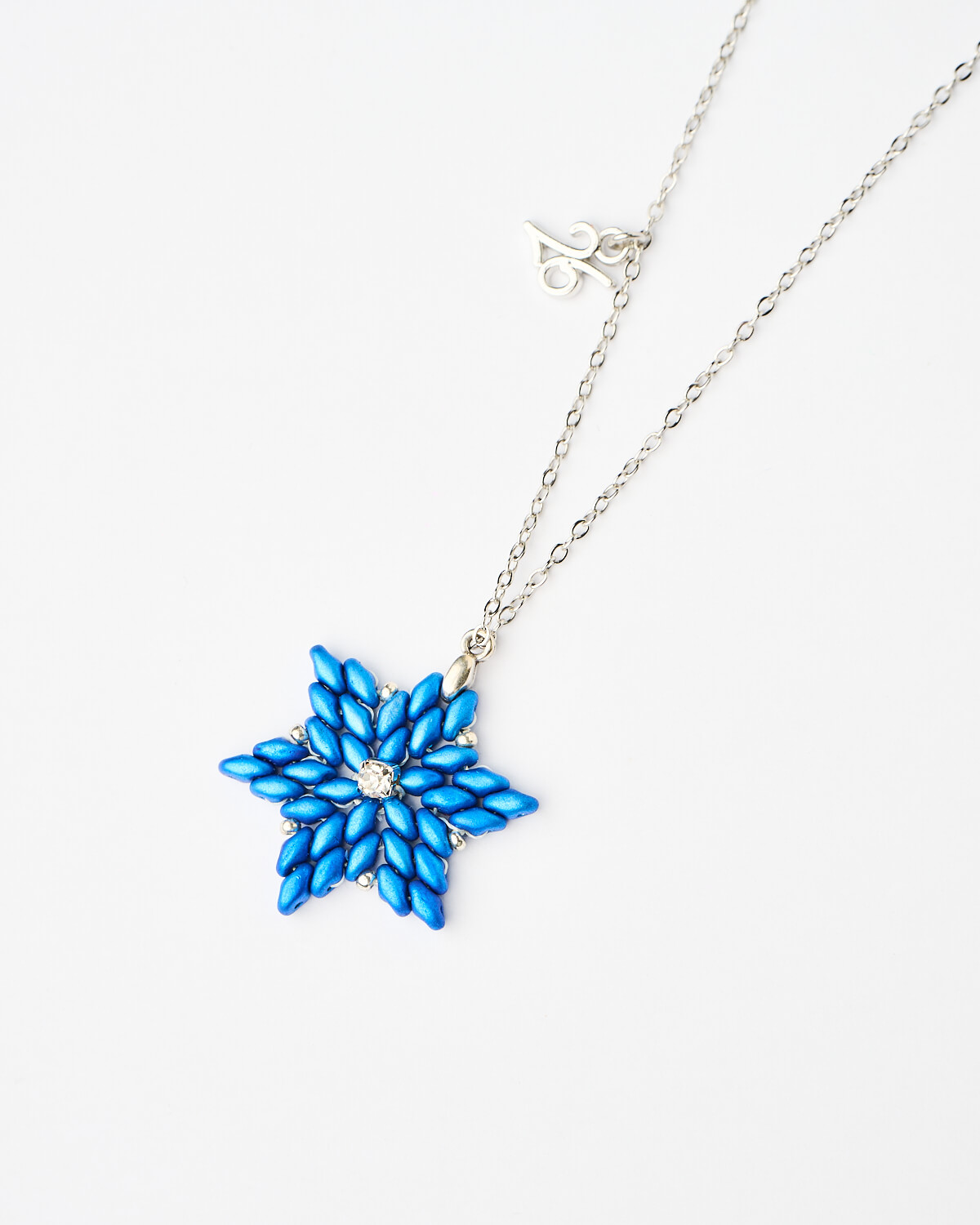 The-Gem-Stories-Blue-Snowflake-Miyuki-Necklace-closeup Close-up of Blue Snowflake Miyuki Necklace with handcrafted beaded snowflake pendant by The Gem Stories