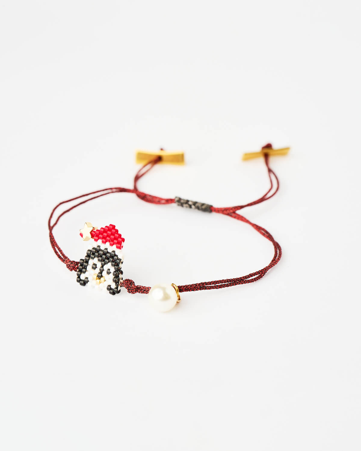 The-Gem-Stories-Festive-Penguin-Miyuki-Bracelet Festive Penguin Miyuki Bracelet with beaded penguin charm on red cord by The Gem Stories