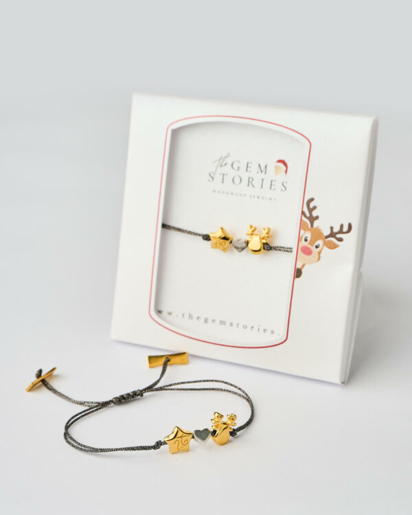 Reindeer Star Charm Bracelet in black with gold charms displayed in festive gift box by The Gem Stories