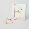 March Flame Heart Bracelet with gold heart and pearl on red cord by The Gem Stories