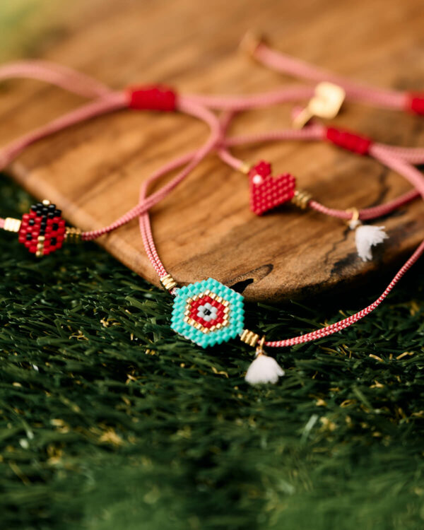 Miyuki evil eye martaki bracelet with red cord and white tassel