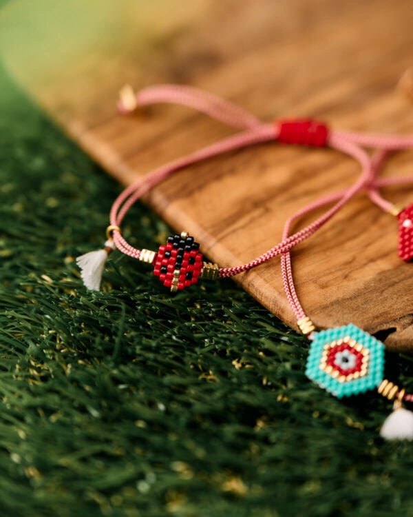 Miyuki ladybug martaki bracelet with red string and tassel detail