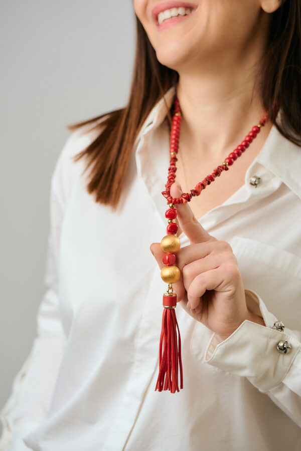 Model wearing Red Coral statement tassel necklace by The Gem Stories