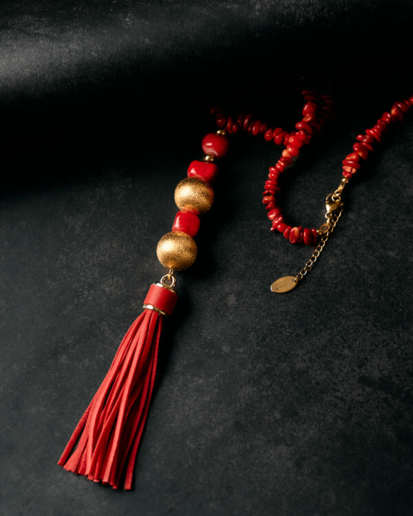 Red coral tassel necklace with gold beads and statement pendant detail