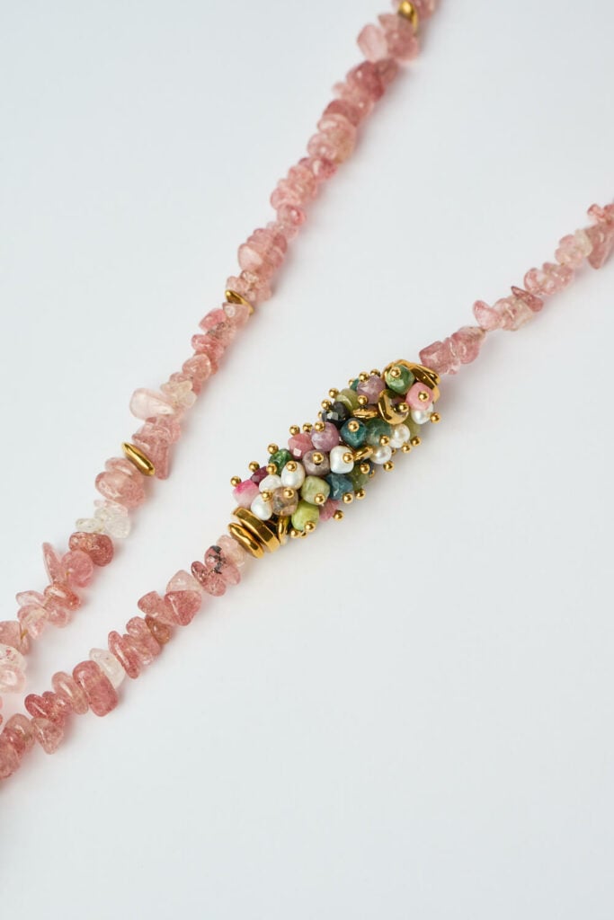 Close-up of the Rose Serenity necklace with pink stones and gold details by The Gem Stories