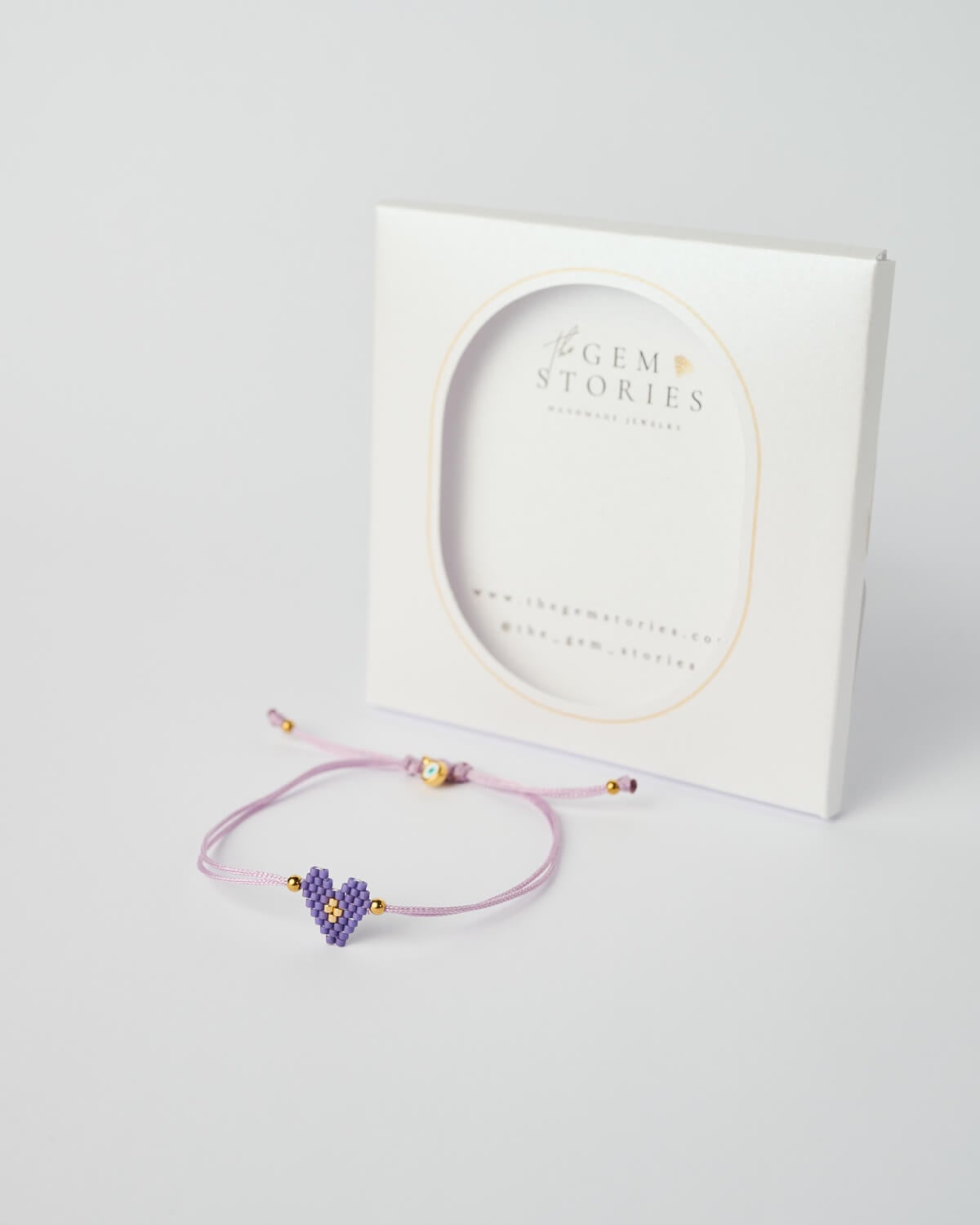 Βραχιόλι Miyuki με γούρι καρδιά – Λιλά Βραχιόλι Miyuki με λιλά καρδιά, ρυθμιζόμενο κορδόνι και χρυσές λεπτομέρειες