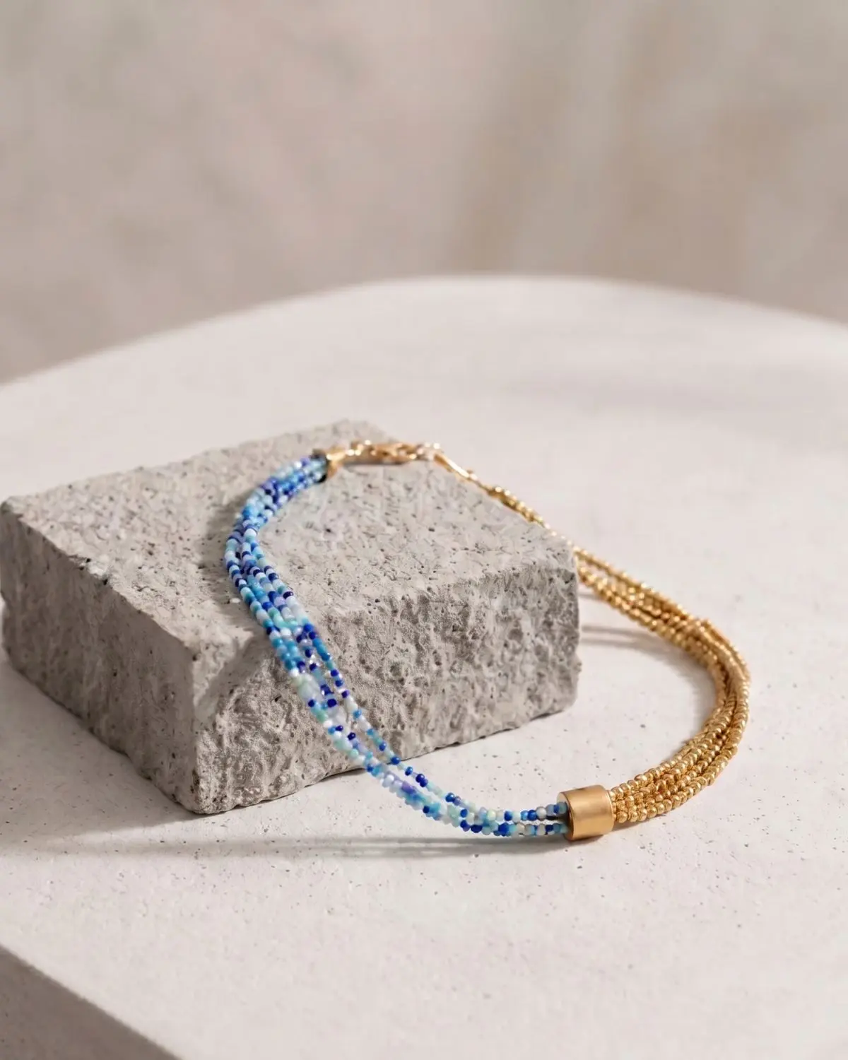 K73731051-The-Gem-Stories-Quadruple-Hematite-Necklace-Blue-Shades-concept Handmade Quadruple Hematite Necklace – Blue Shades Concept featuring layered hematite elements and elegant blue-toned details.