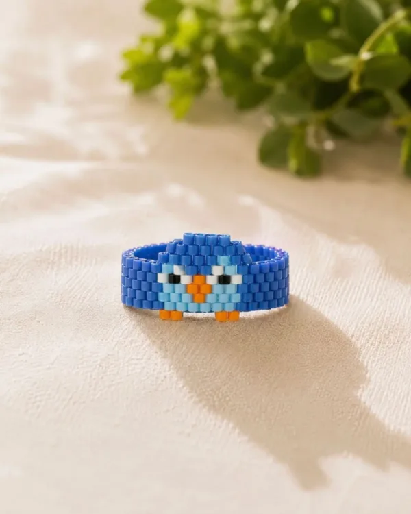 Handmade Pico Penguin bracelet featuring a cute penguin design made with black, white, and yellow Miyuki delica beads by The Gem-Studio.